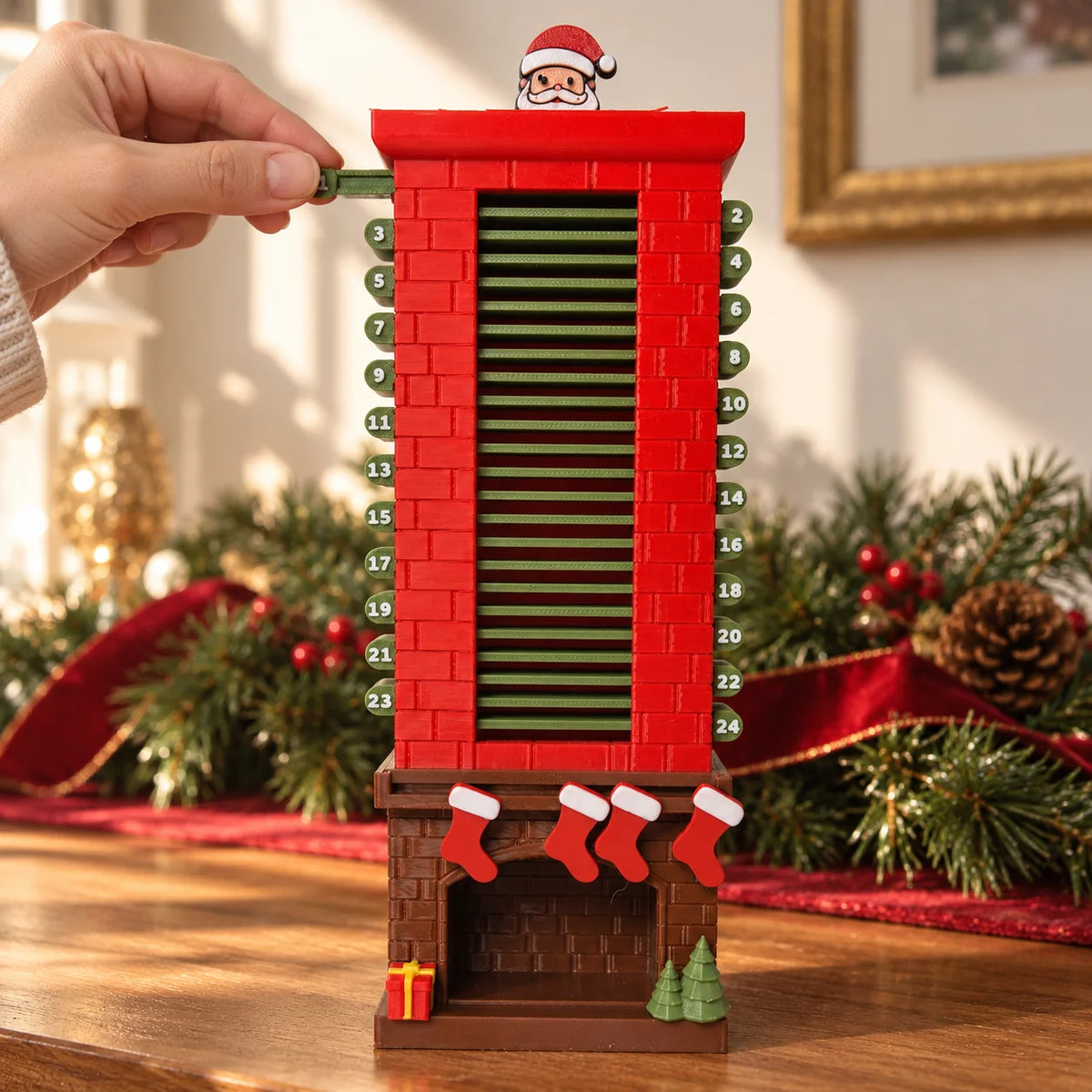 Adult fingers pulling the first green numbered tab from the Santa chimney countdown calendar.