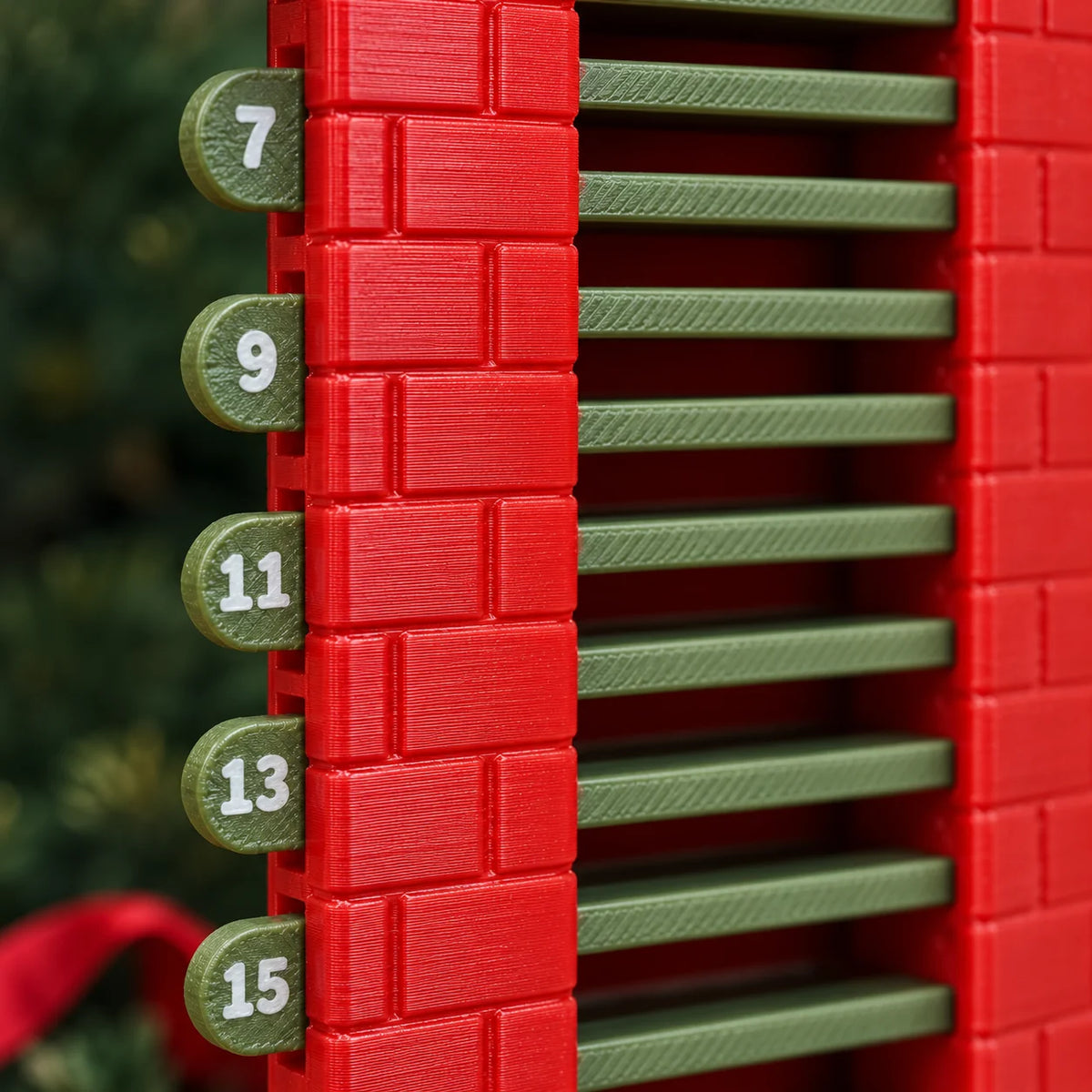 Close detail of the calendar’s textured red plastic chimney, olive green slats and numbered tabs.