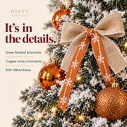 Bronze Snowfall detail showing flocked foliage, copper-tone ornaments and ribbon bows