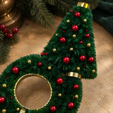 Close detail of Christmas Glow's tree and wreath, red ornament accents and gold trim.