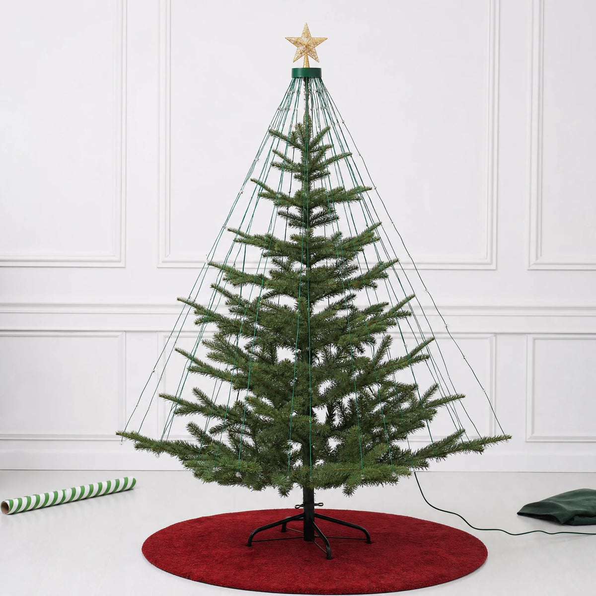 Unlit cascading LED strands arranged vertically down the branches of a Christmas tree