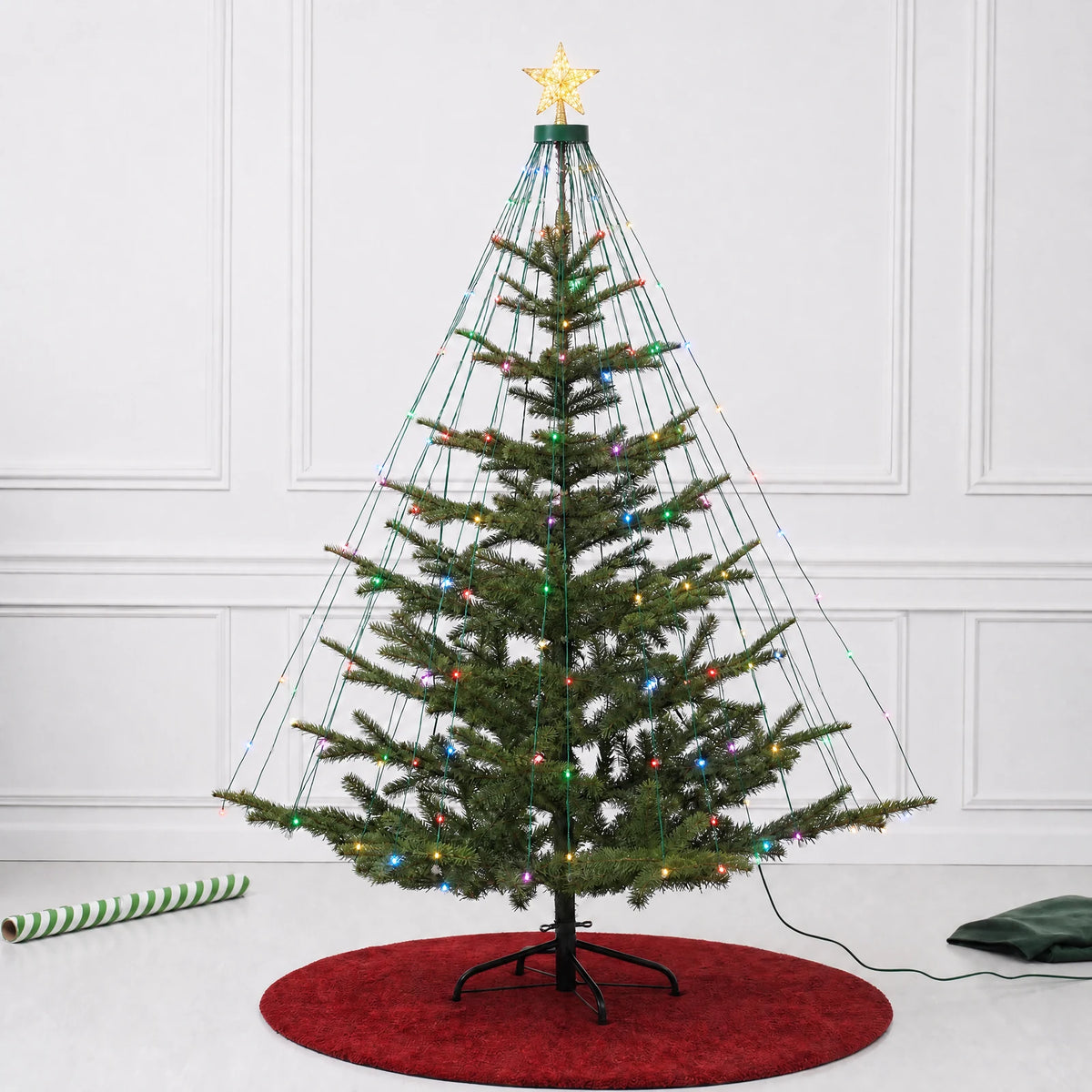 Christmas tree with the star topper and cascading strands illuminated in a festive color palette