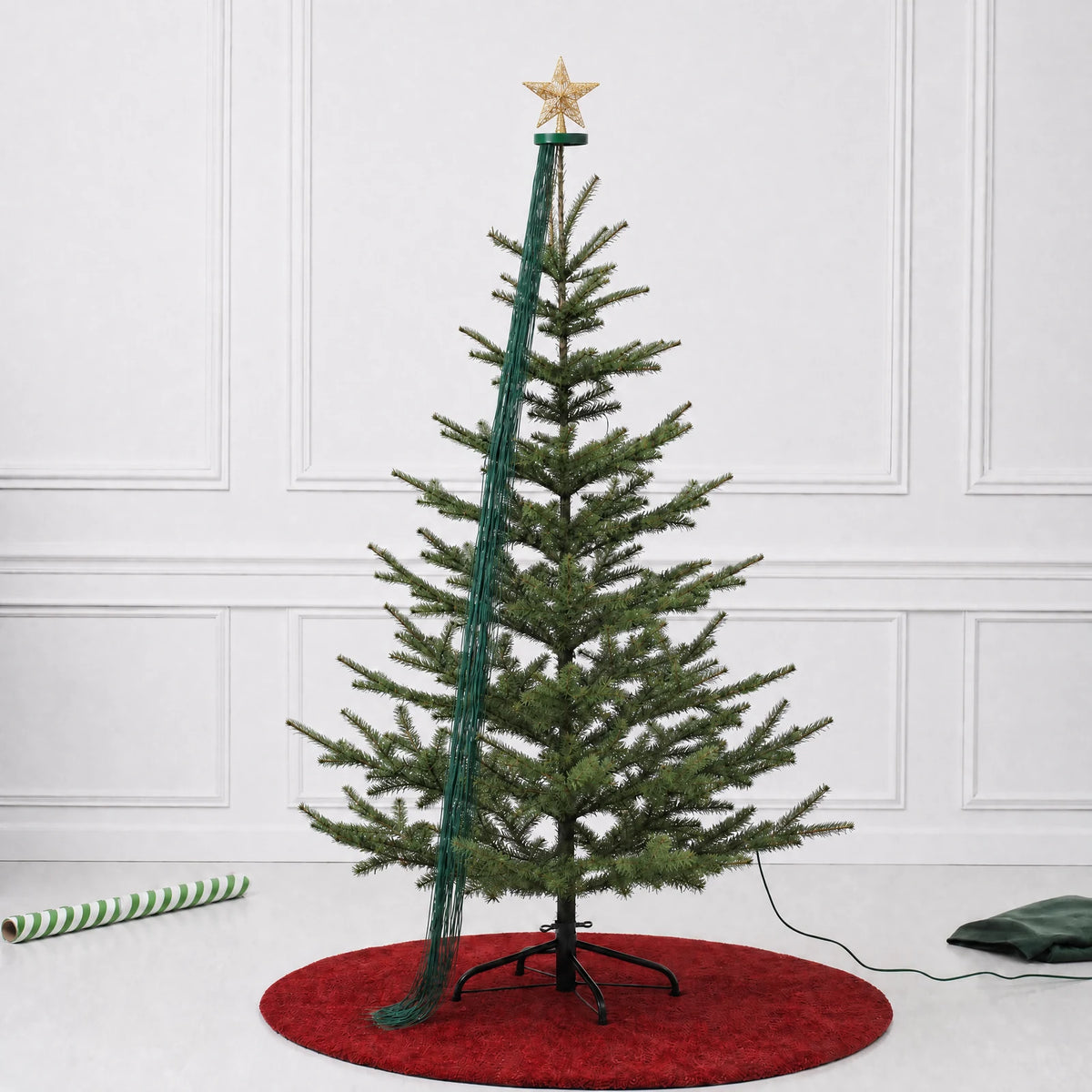 Star topper and top collar positioned on a tree with the light strands gathered at the top